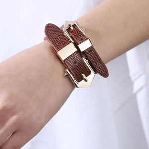 Brown faux lizard skin wrap bracelet with gold metal buckles on a model