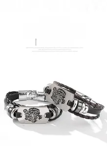 Detail of woven leather bracelets in black and brown featuring silver tiger head motifs