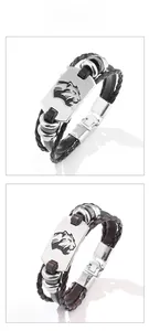 Dettagli di bracciali in pelle intrecciata nera e marrone con placche di leopardo incise