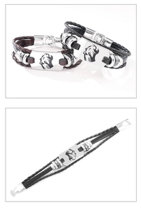 Dettaglio del bracciale in pelle intrecciata con ciondolo a testa di leone in argento