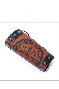 Close-up of Viking compass design on brown leather bracer with silver metal rivets