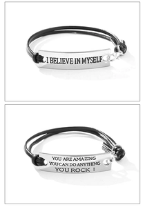 Detail of inspirational braided leather bracelets with engraved silver plates and slogans