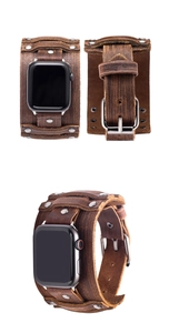 Detail of vintage brown leather wide cuff watch strap with silver metal rivets