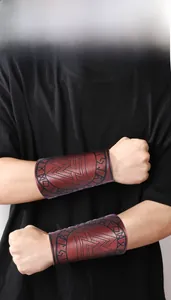 Detail of Viking leather wrist guards with embossed runes and triangle patterns