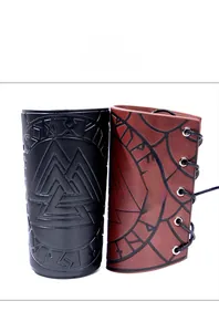 Detail of vintage leather arm guards with embossed Viking valknut and rune patterns