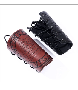 Detail of Viking arm guards with embossed Valknut symbols and Nordic rune patterns