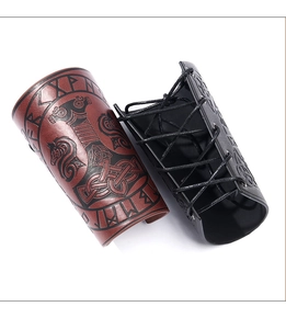 Close-up of Viking leather bracers featuring Nordic runes and Mjolnir relief patterns