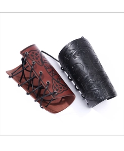 Detail of Viking leather bracers with embossed Mjolnir and Celtic knot patterns