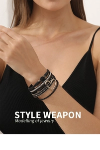 Close-up of multi-layer leather bracelet with gold hollow heart and sparkling rhinestones
