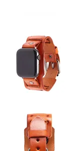 Detail of vintage brown leather apple watch strap with metal rivets and pin buckle