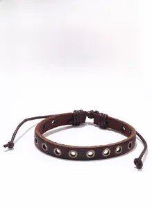 Detailed view of punk braided leather bracelet with vintage metal eyelets and drawstring
