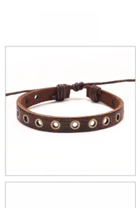 Detail view of brown leather punk bracelet with brass eyelets and adjustable cord