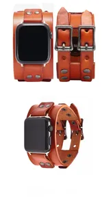 Detail view of vintage brown leather cuff watch band with double buckles and studs