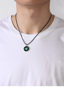 Close-up of a luminous infinity symbol pendant with dark starry background on a black cord