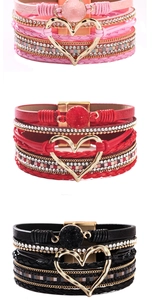 Detail of bohemian multilayer leather bracelets with heart charm and magnetic clasp