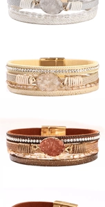 Detail of bohemian leather bracelets featuring druzy stone charms and magnetic clasps
