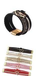 Detail of bohemian multilayer leather bracelets with magnetic clasp and crystal heart