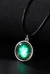 Macro detail of glowing Capricorn constellation pendant with green luminous effect