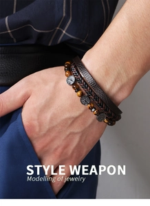 Close-up of men's layered leather bracelet with tiger eye beads and Tree of Life charms