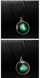 Detailed macro view of Capricorn and Sagittarius glow-in-the-dark glass necklaces