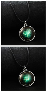 Detailed macro view of Leo and Pisces luminous constellation necklaces with black leather cord