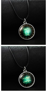 Detailed view of luminous zodiac pendants with Gemini and Aquarius glass cabochon charms