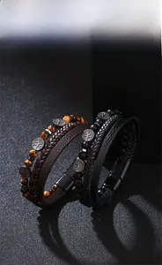 Detail of multi-layer leather bracelets with tiger eye beads and Tree of Life charm