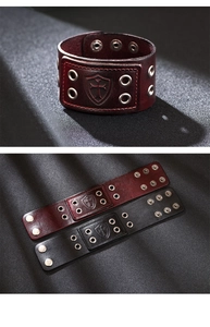 Macro detail of leather cross bracelets in black and wine red with metal eyelets