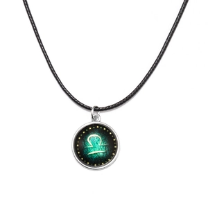 Luminous Libra zodiac necklace with glowing glass pendant on black cord strap