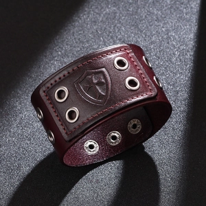 Vintage burgundy leather wide cuff bracelet with embossed cross and metal rivet details