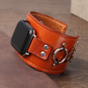 Retro orange-brown leather strap with silver rivets for Apple Watch on dark wood table