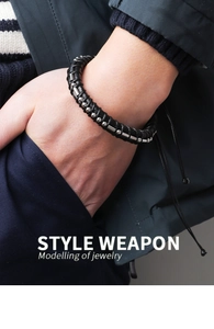 Close-up of black braided leather bracelet with silver beads on male wrist