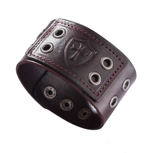 Classic punk leather bracelet in dark brown with embossed cross shield and metal grommets
