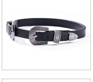 Détail d'une ceinture vintage en cuir noir avec boucle et embout en métal argenté gravé
