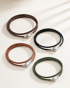 Close-up of multicolored braided leather bracelets with cylindrical metal clasps