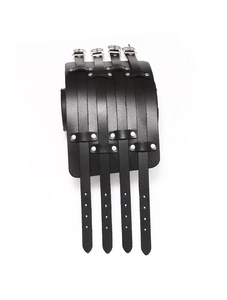 Close-up of black leather punk wristband featuring four adjustable metal buckles and silver rivets