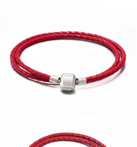 Detail view of double-wrap red leather braided bracelet with polished silver metal clasp