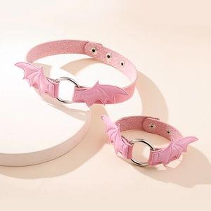 Pink leather choker set with gothic bat wings and metal rings on a display stand