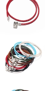 Close-up of multicolored braided leather bracelets with cylindrical metal screw clasps
