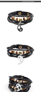 Close-up of multilayer leather bracelet featuring wooden beads and Yin Yang Tai Chi charm