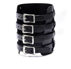 Detail of a punk style black wide leather wristband with four adjustable silver buckles