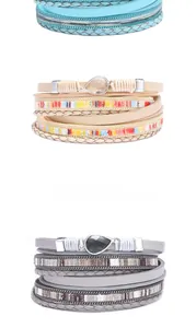 Detail view of multilayer leather wrap bracelets with crystal drop pendants and magnetic clasp