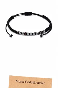 Detail of adjustable Morse Code bracelet with hematite and wooden beads on double cord