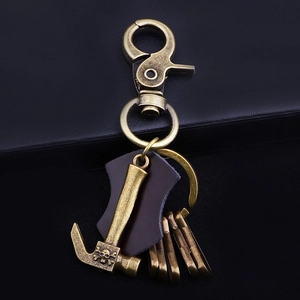 Vintage bronze hammer keychain with skull pattern and brown leather on four split rings