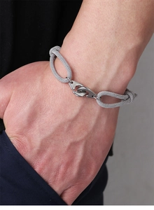 Close-up of a grey woven rope bracelet with a polished silver stainless steel buckle