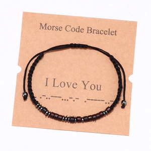 Handmade Morse Code bracelet with wood beads representing I Love You on a kraft card