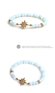 Détail d'un bracelet en perles d'opale avec pendentif étoile dorée et zircon