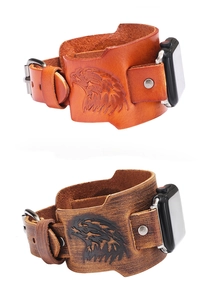 Close-up of leather watch bands with eagle totem embossing and metal buckle detail