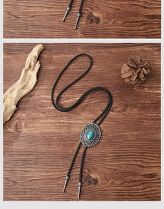 Detailed close-up of retro Western bolo tie with turquoise stone and silver floral tips