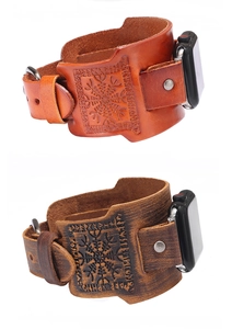 Macro view of wide leather watch bands with Viking compass rune embossing and metal buckles